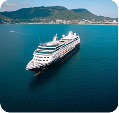 Cruise ship sailing near a mountainous coast